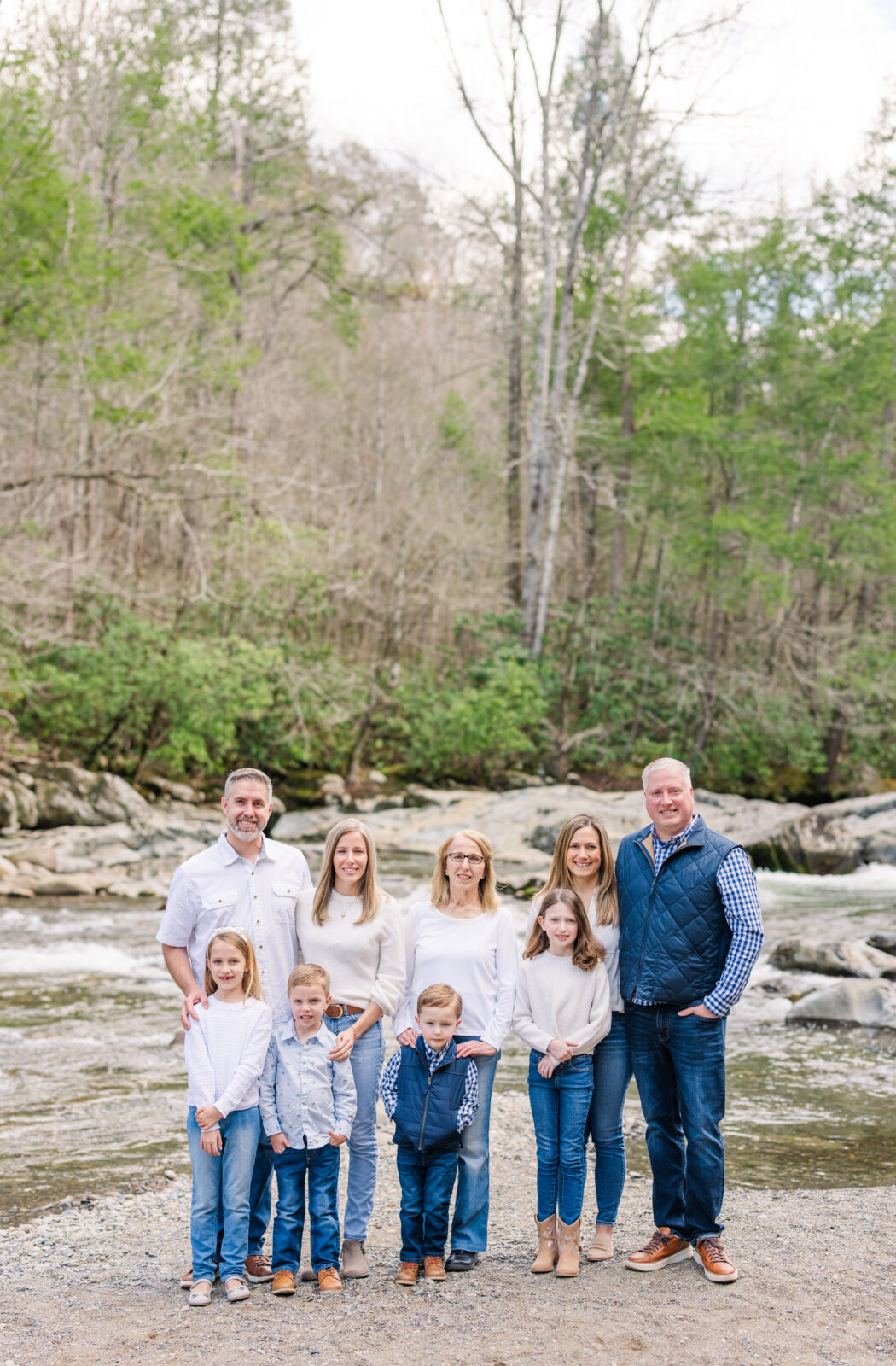 Extended family session in Gatlinburg, TN with a smiling family by a river