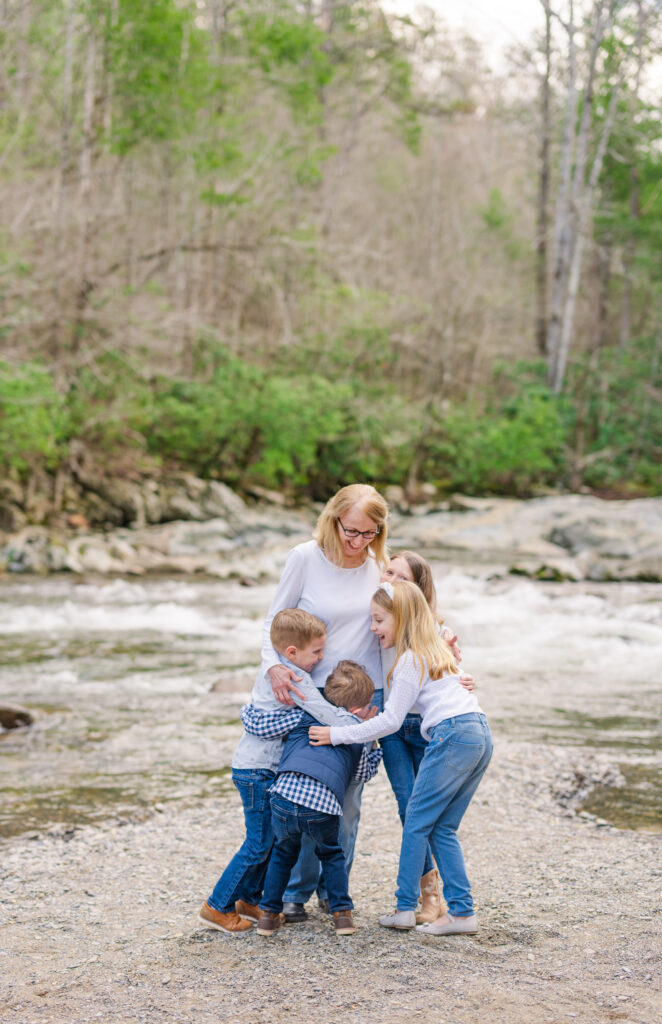 grandkids hug grandma during their family session while on vacation in gatlinburg, Tennessee taken by a photographer in the Smoky Mountains