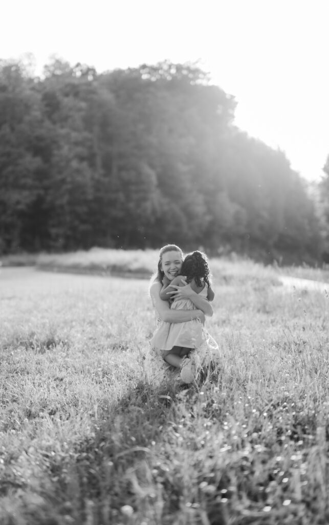 Gatlinburg family photographer documents sweet mother–daughter hug at sunset in the mountains.