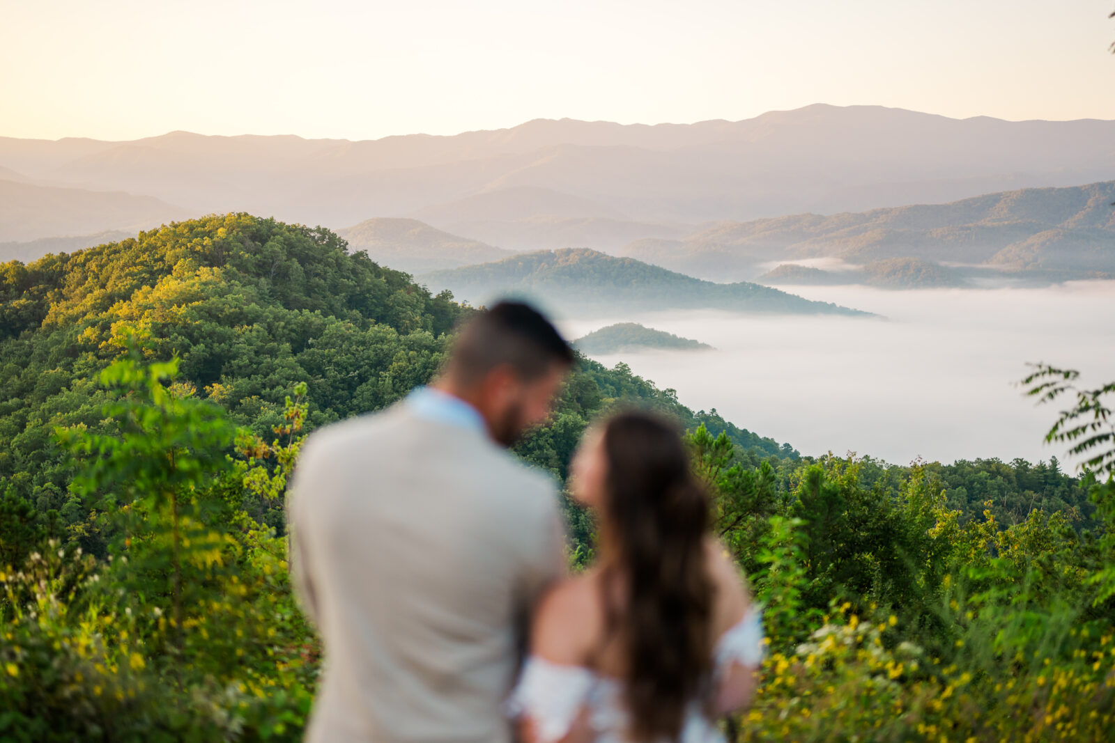 Couple sharing a quiet moment during their Smoky Mountain elopement, gazing at each other while the misty mountains in Gatlinburg stand beautifully in focus behind them.