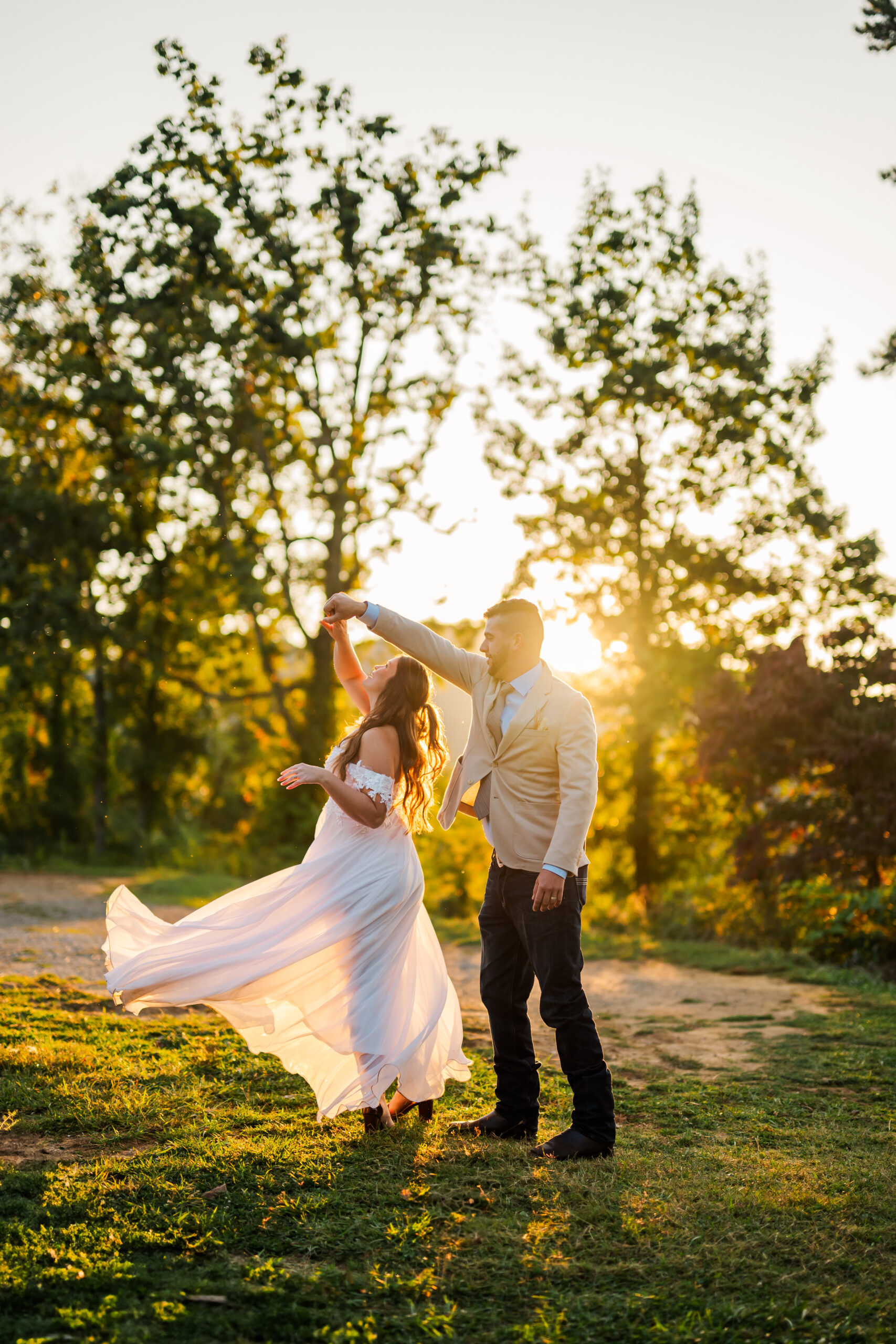 Bride and groom dancing at sunrise in the Smoky Mountains with golden light glowing behind them — romantic Gatlinburg elopement photography.