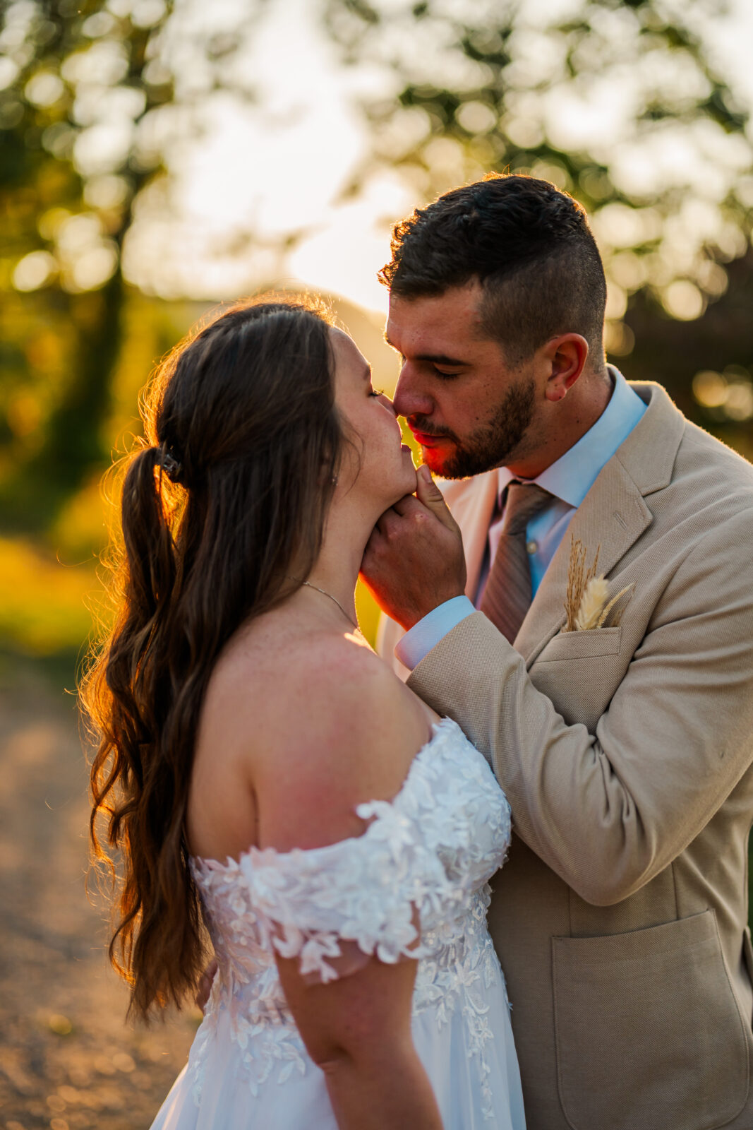 Intimate almost-kiss as groom tilts his bride’s chin up toward him, bathed in sunrise glow during a Smoky Mountain elopement in Gatlinburg.