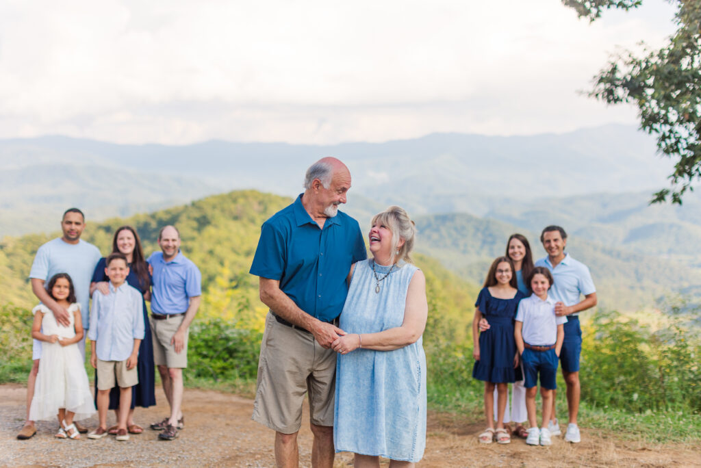 Couples within a family group together and are clumped aesthetically in groups for a family portrait in Gatlinburg, TN either the Smoky Mountains in the background