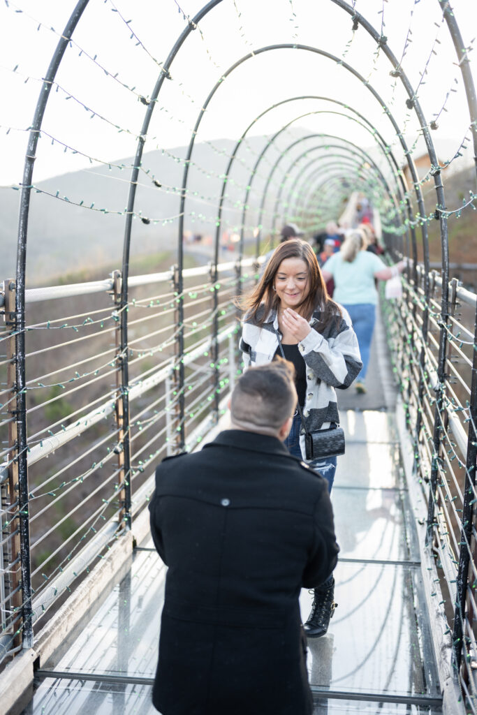 a man proposing to a woman on the skybridge in gatlinburg