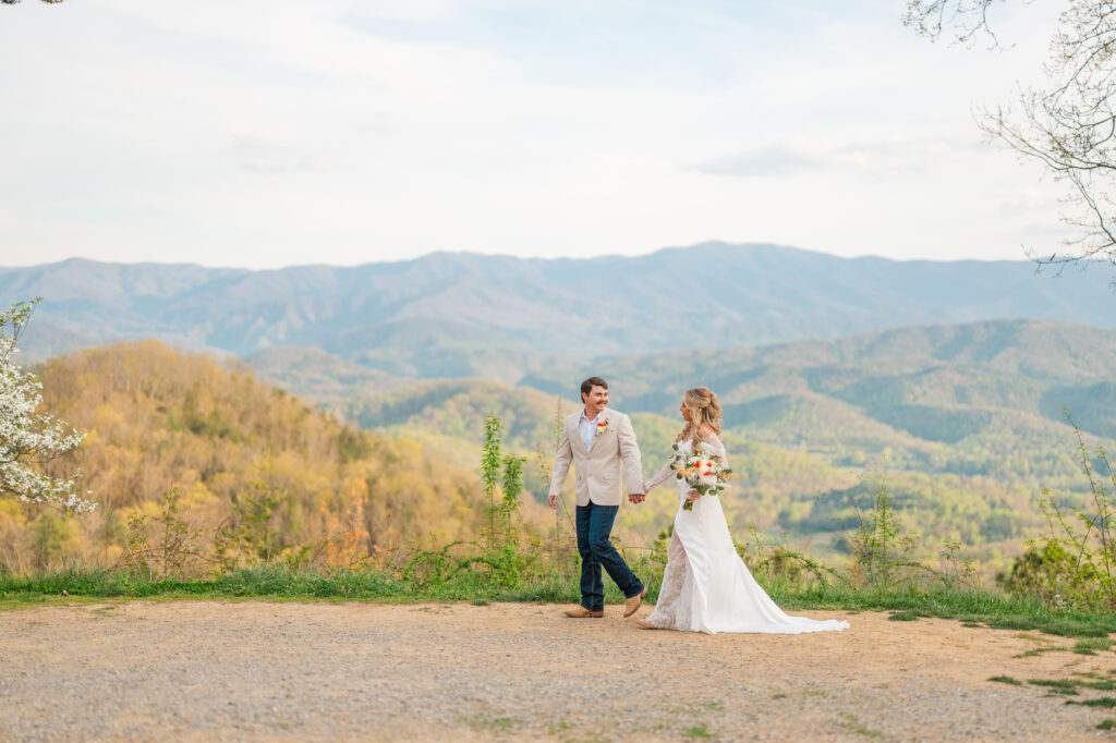 a couple walking with the smoky mountains in the background