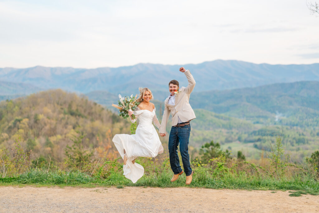couple jumps up excitedly after getting married in the great smoky mountains national park
