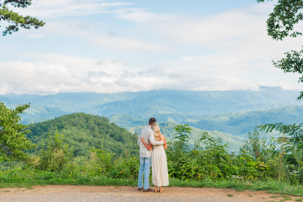Couple standing in an embrace overlooking the great smoky mountains national park during their engagement session