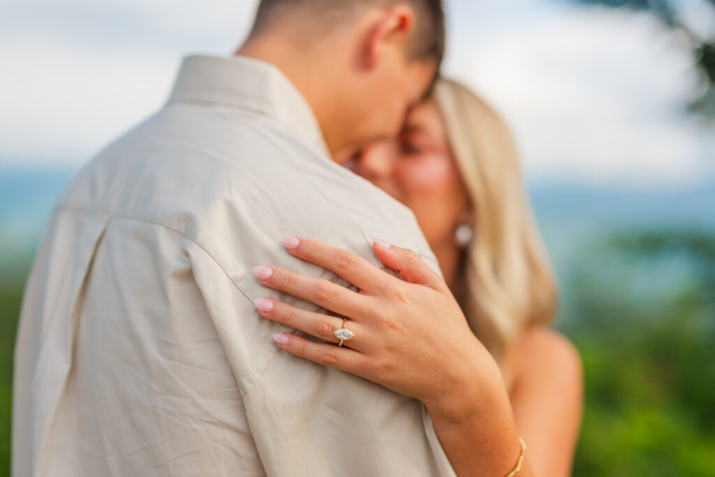 couple embracing showcasing engagement ring in Townsend tennessee